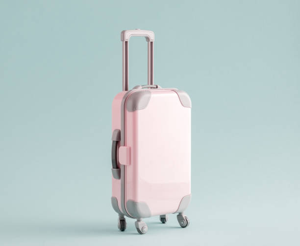 istock Pink suitcase on blue background. Copy space. Travel concept. 1375025732