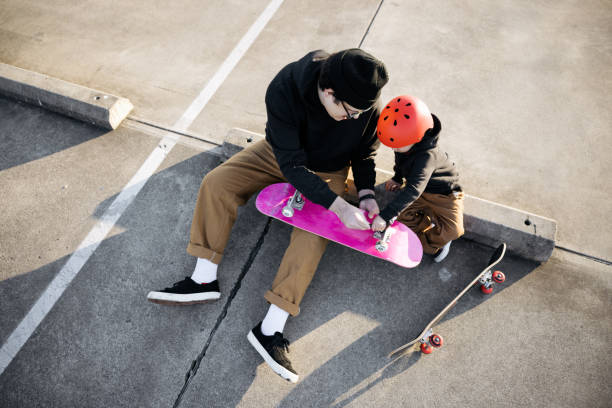 istock Father Skateboarding With His Son 1375025813
