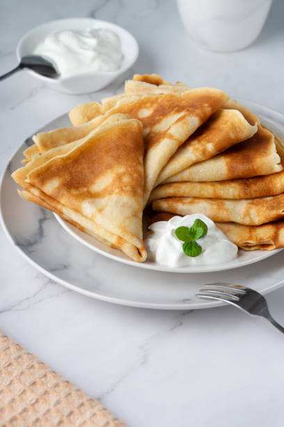 istock Stack of russian thin pancakes blini with fresh sour cream 1375025901