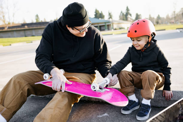 istock Father Skateboarding With His Son 1375026025