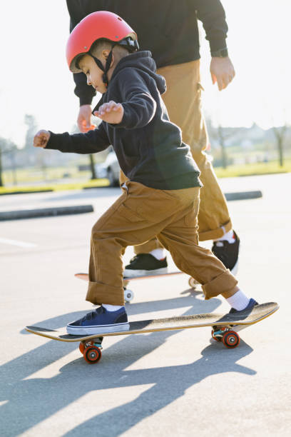 istock Father Skateboarding With His Son 1375026132