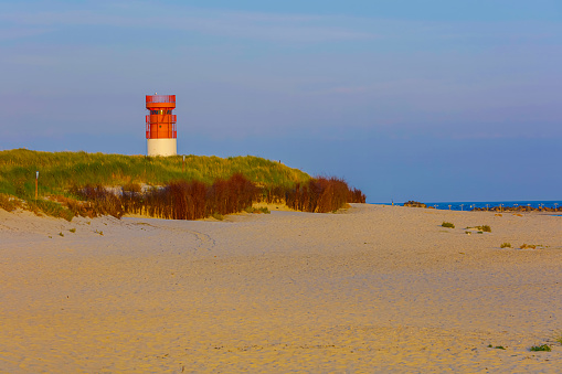 Lighthouse On Beach Against Sky