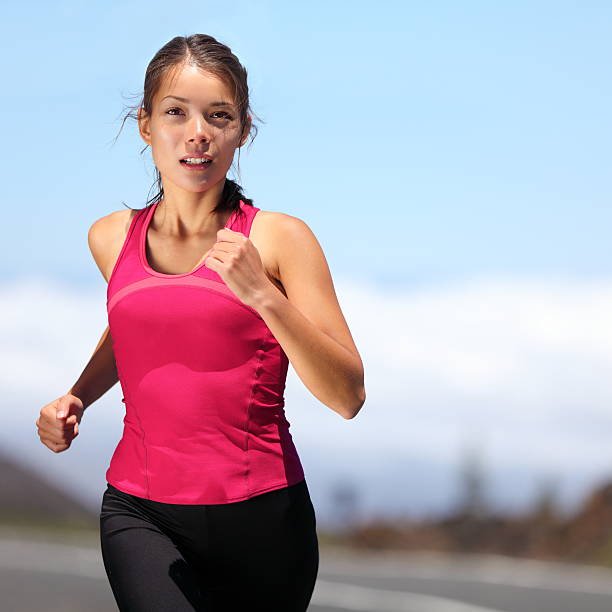 runner - woman running runner - xwoman running outdoors training for marathon run. Beautiful fit asian fitness model in her 20s. Click for more: off track running stock pictures, royalty-free photos & images