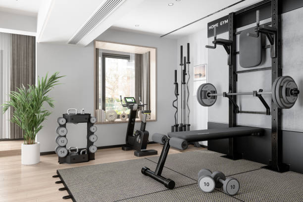 Home Gym With Barbell, Dumbbells, Exercise Bike And Other Sports Equipments Home Gym With Barbell, Dumbbells, Exercise Bike And Other Sports Equipments health club stock pictures, royalty-free photos & images