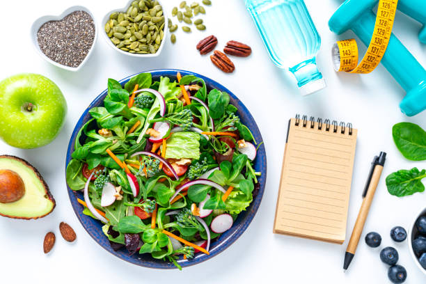 istock Healthy fresh vegetables salad plate and note pad 1375039165