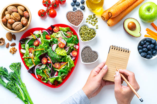 健康的な果物や野菜のサラダのレシピ - nut directly above multi colored food ストックフォトと画像