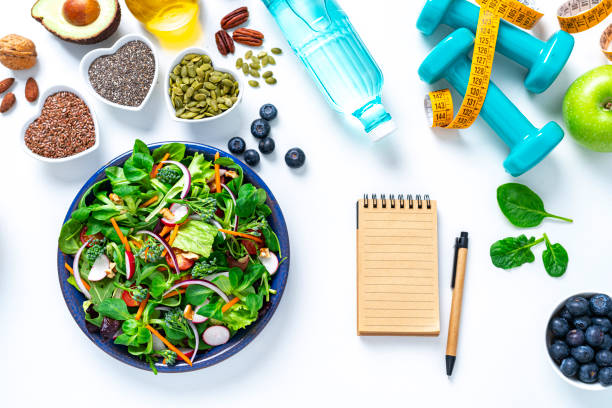 istock Healthy salad plate and note pad on white table 1375039726