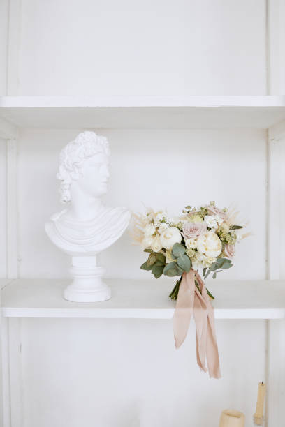 istock The wedding bouquet is on a white shelf next to a plaster sculpture 1375042418