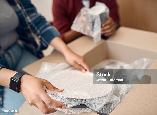 Shot Of A Young Couple Unpacking Boxes In Their New Home Stock Photo - Download Image Now