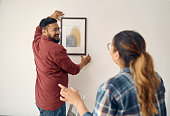 istock Shot of a young couple decorating their house together 1375049899