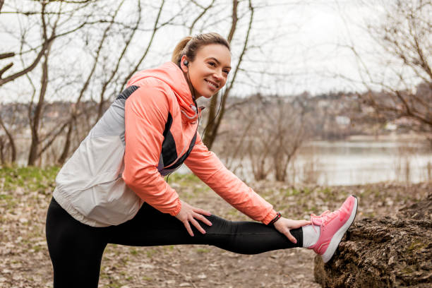 istock Young active athletic woman stretching her leg muscles in public park 1375056111