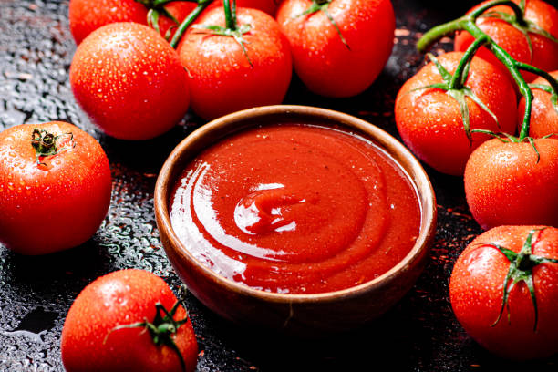 istock Tomato sauce with a branch of fresh tomatoes. 1375061825