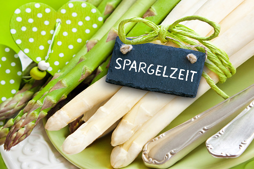 German lettered sign and Asparagus Season with green table decoration