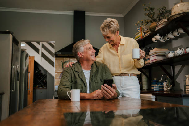 istock Caucasian elderly couple drinking coffee in kitchen 1375063018