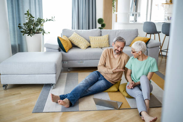 istock Mature couple at home using laptop 1375063132