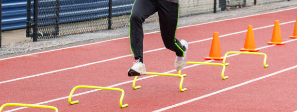 istock Runner running over six inch hurdles on a track 1375063343