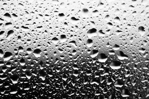 close up of water drops on glass surface, black and white toned