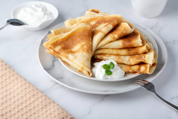 istock Stack of russian thin pancakes blini with fresh sour cream 1375066066