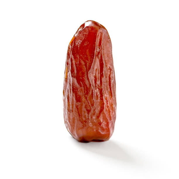 istock One dry date isolated on white with shadow. Close-up 1375067653
