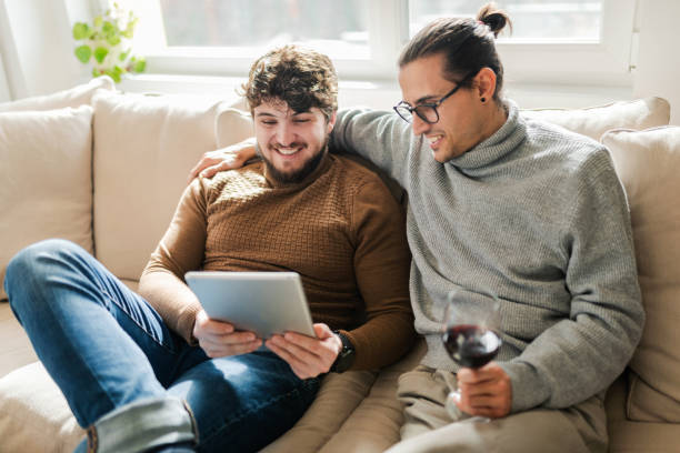 istock Gay couple at home using internet / tablet 1375081491
