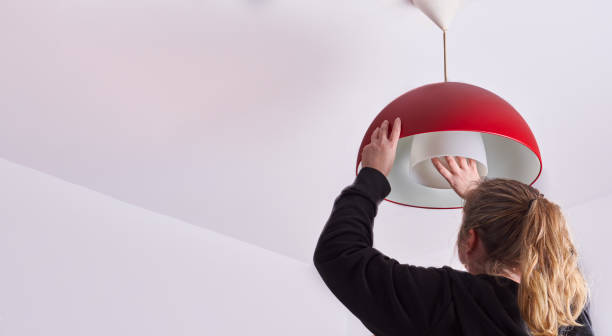 istock unrecognizable blonde woman changing a light bulb at home, DIY 1375091596
