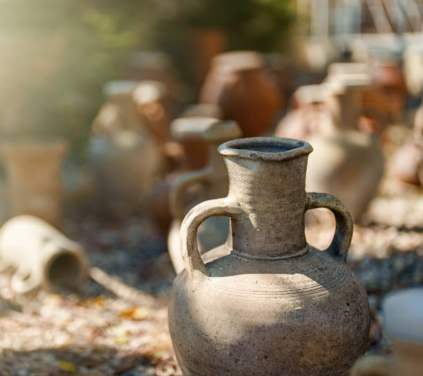 Handmade vase without mouth neck with several handles and that seems very damaged and eroded by the passage of time.