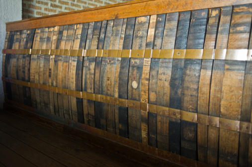 Row of planks of whiskey barrels used as wall