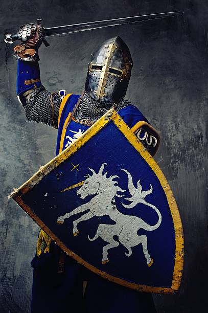 istock Blue medieval knight with sword raised and shield up 137512878