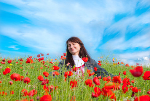 smiling girl in a poppy field