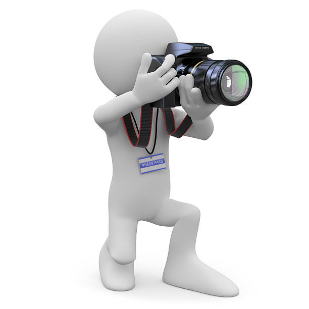 istock Photographer kneeling with his SLR camera 137513480