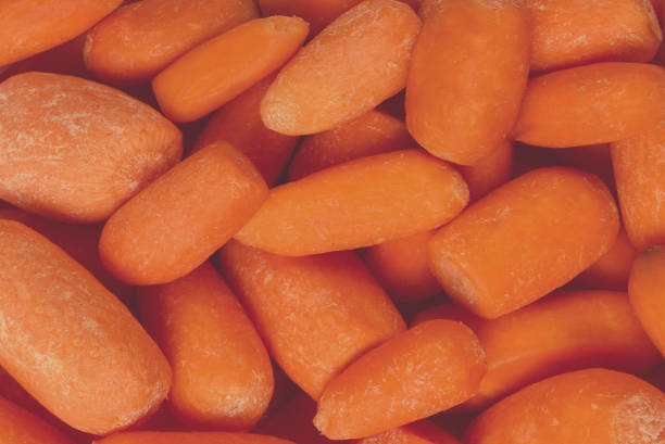 istock Little fresh carrots as a background. Snack. 1375135841
