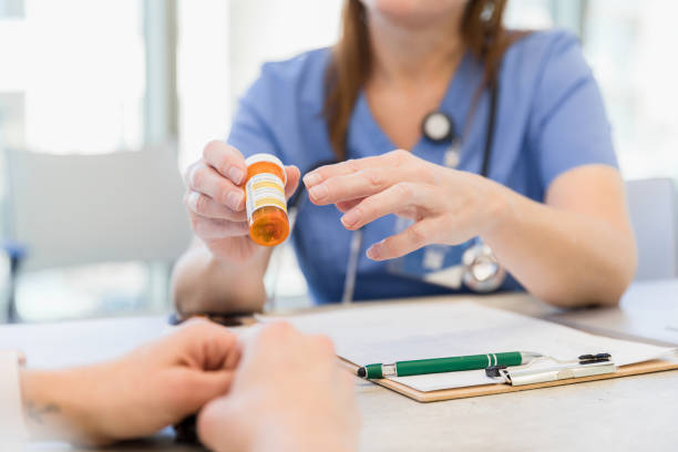 Unrecognizable female doctor discusses medication with patient