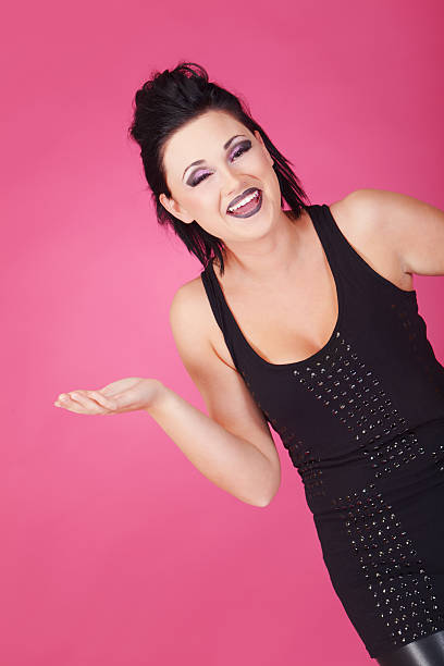Pink mode Laughing emo-girl on pink background black hair emo girl stock pictures, royalty-free photos & images