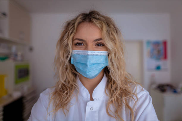 istock Caucasian female dentist, wearing protective face mask in ordination 1375150944