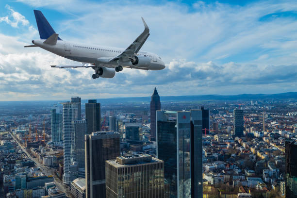 Plane flying over Skyline of Frankfurt Germany stock photo
