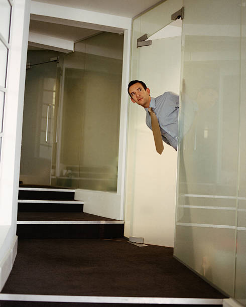 istock Businessman looking round a door in the office 137520170