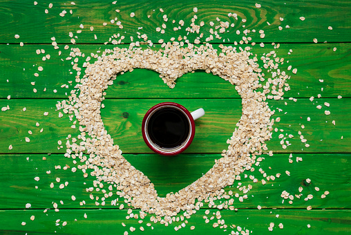 cup of coffee and coffee beans in heart shape with copy space