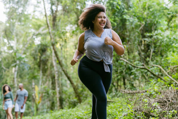 istock Plus size woman running in the natural park 1375209289