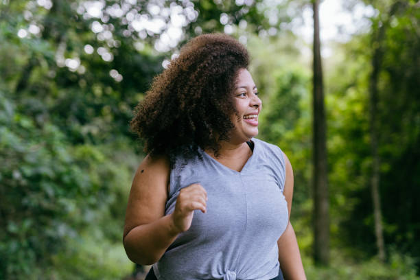 istock Plus size woman running in the natural park 1375209291