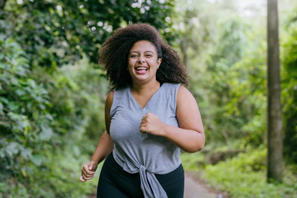 istock Plus size woman running in the natural park 1375209295