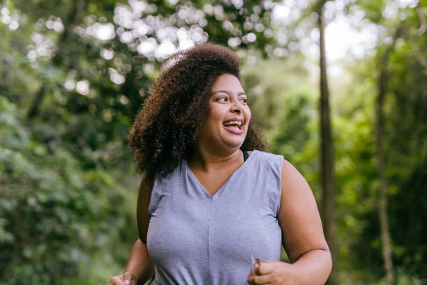istock Plus size woman walking in the natural park 1375209301