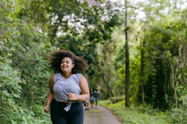 istock Plus size woman running in the natural park 1375209305