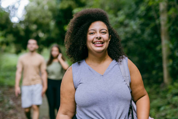 Plus size woman walking in the natural park