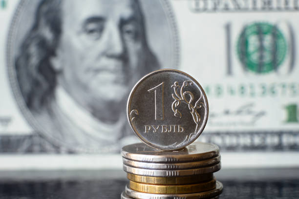 istock Russian ruble coin on background of dollar bill 1375213742