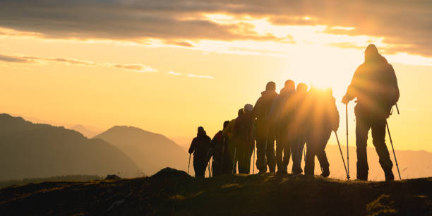 istock Hikers against golden sunset sky 1375219365
