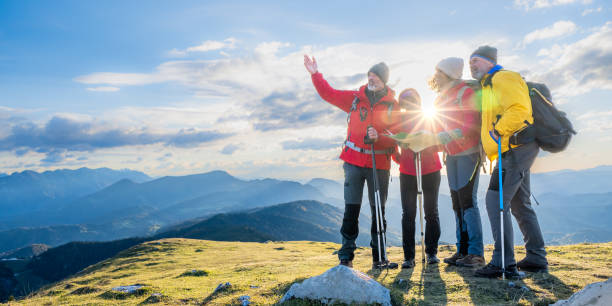 istock Group of hikers standing on summit and enjoying view 1375219421