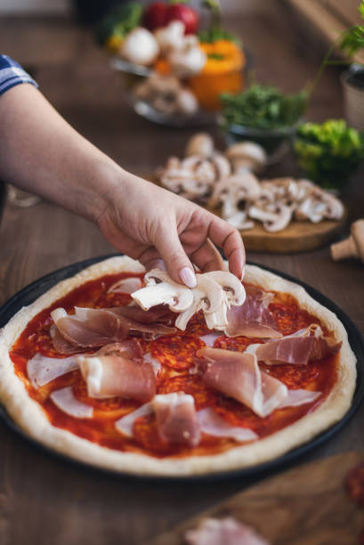 istock Women Preparing Fresh Homemade Pizza 1375220558