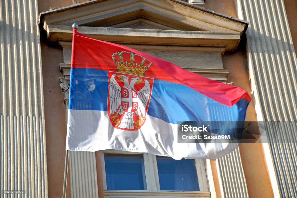 State Flag of the Republic of Serbia at the University building in city of Nis, Serbia State Flag of the Republic of Serbia at the University building in city of Nis, Serbia, on a blowing in wind. Serbia Stock Photo
