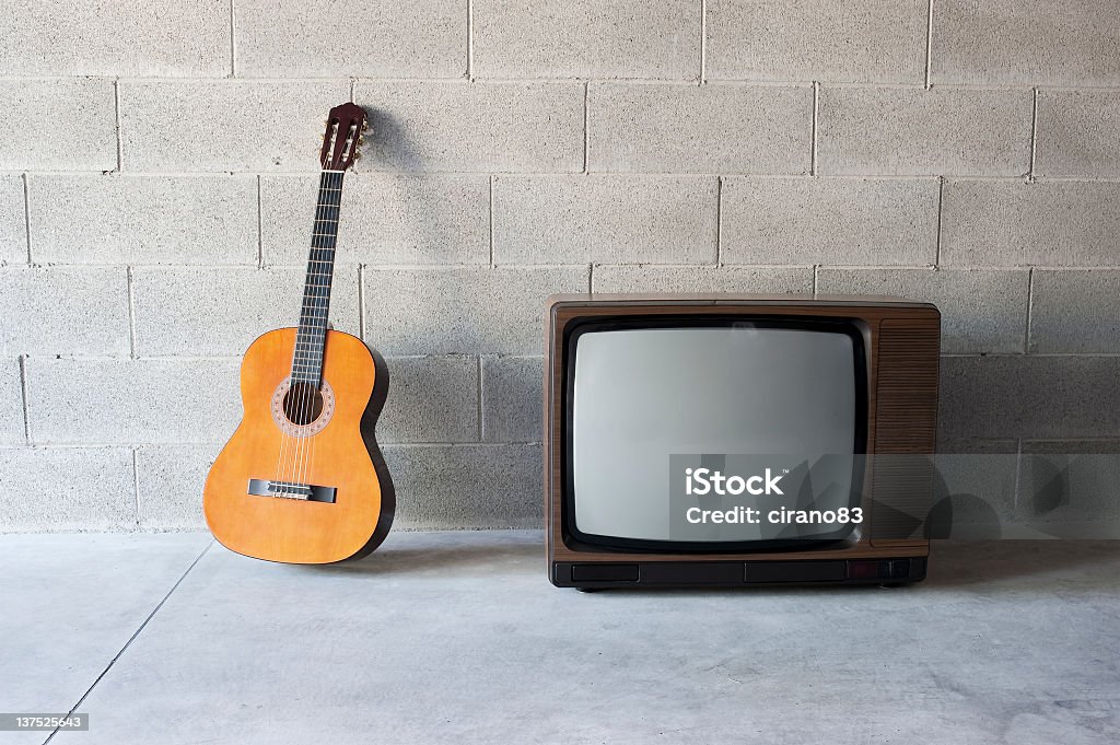 Spanish Guitar And Old Television Spanish guitar and old television. Old-fashioned style music television. Guitar Stock Photo