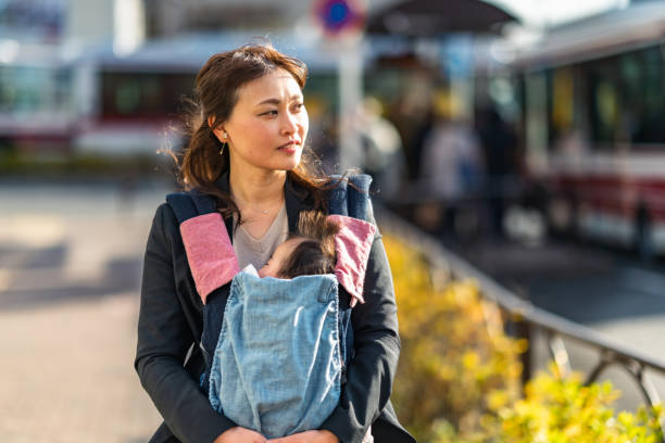 istock Working mother commuting in the city with her baby 1375257567